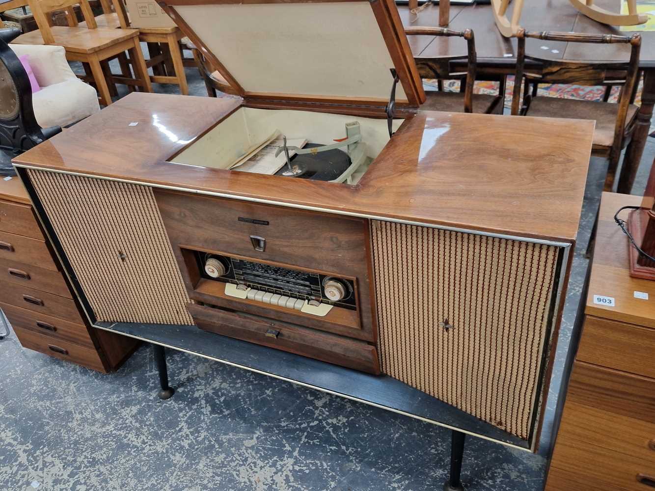 A retro arm chair together with a 1960's radio gram.