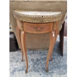 A marble topped gilt edged inlaid small demi lune hall table.