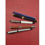 Four Waterman fountain pens and one other.