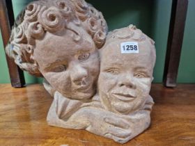 An interesting pottery sculpture, two children. signiture stamp to base