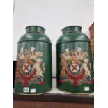 A pair of green painted tole tea cannisters, each with an armorial