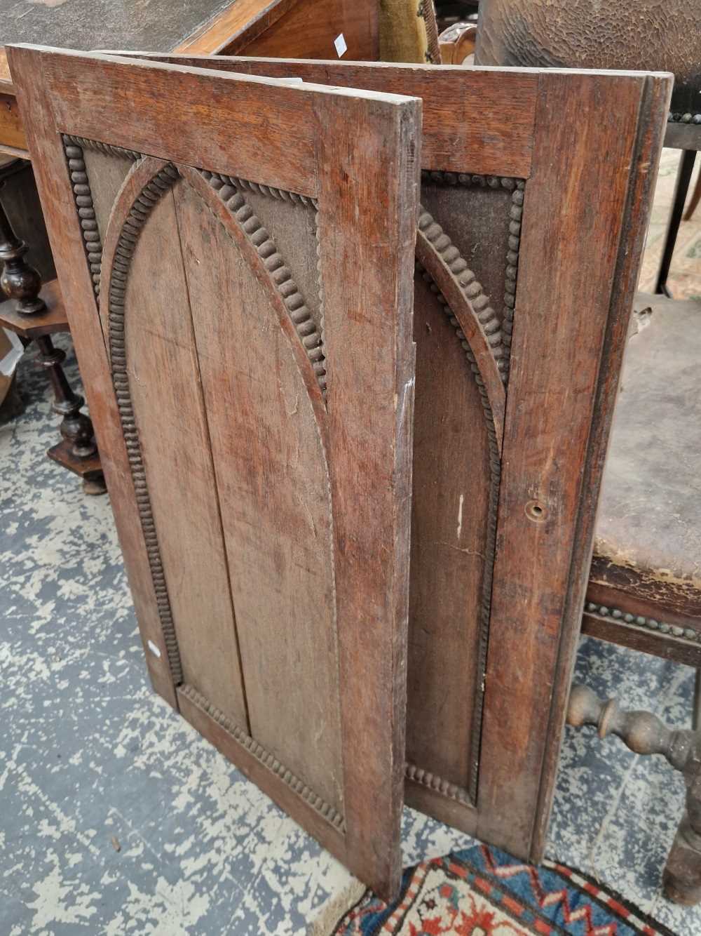 A pair of antique oak cabinet doors.