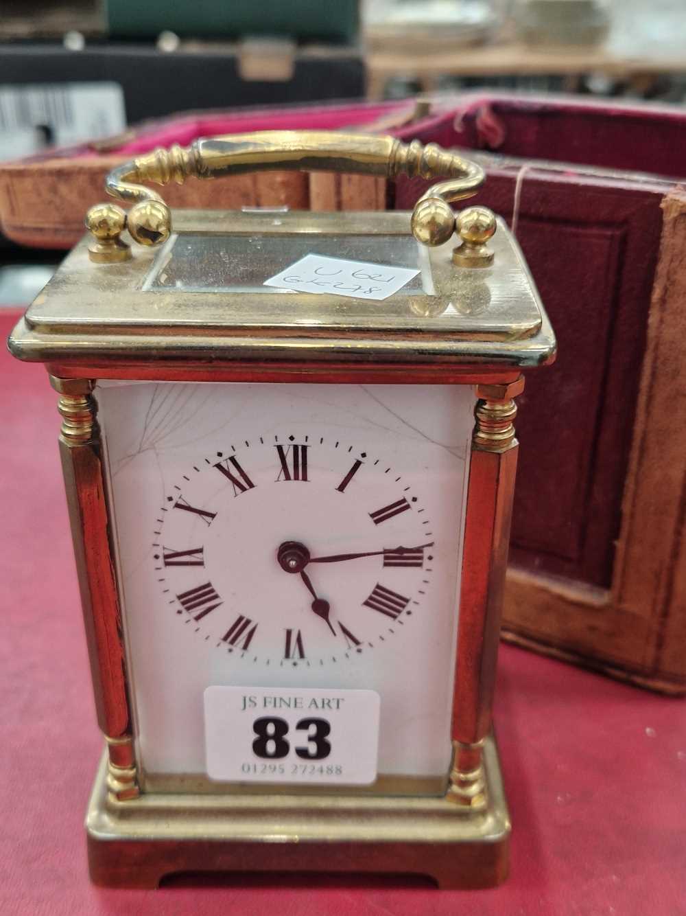 A vintage brass cased carriage clock with leather outer travelling case.