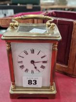 A vintage brass cased carriage clock with leather outer travelling case.