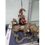 A brass tiger, a dragoin and a bird  form oil lamp together with a painted iron Mr Punch doorstop