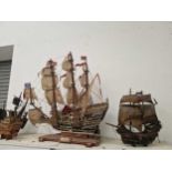 Four wooden model galleons in full sail