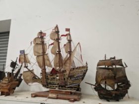 Four wooden model galleons in full sail