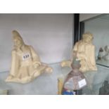 Two Edition Kaza, French straw coloured seated pottery figures together with a tinted glass scent