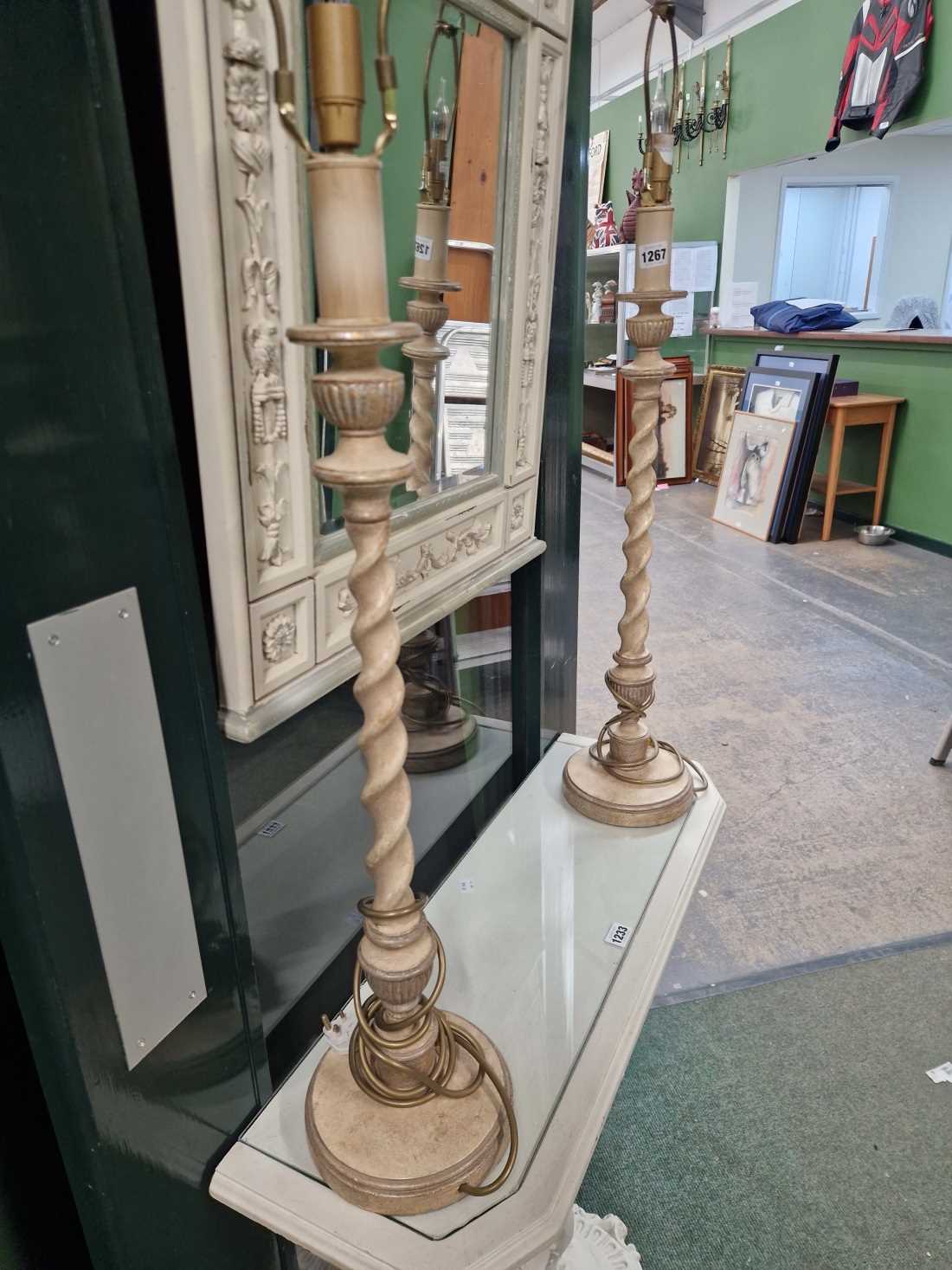 A pair of painted barley twist table lamps.