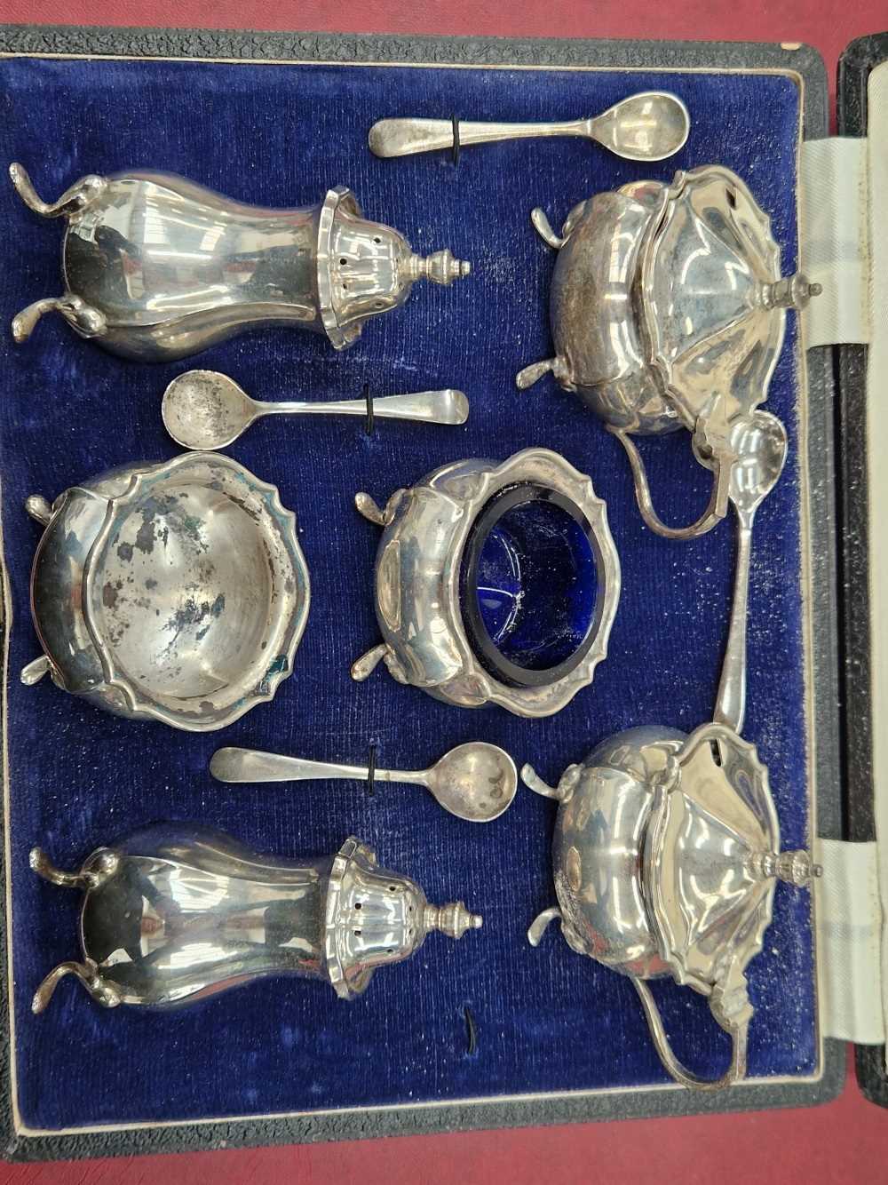 A cased hallmarked silver six piece cruet set.