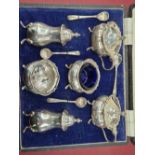 A cased hallmarked silver six piece cruet set.