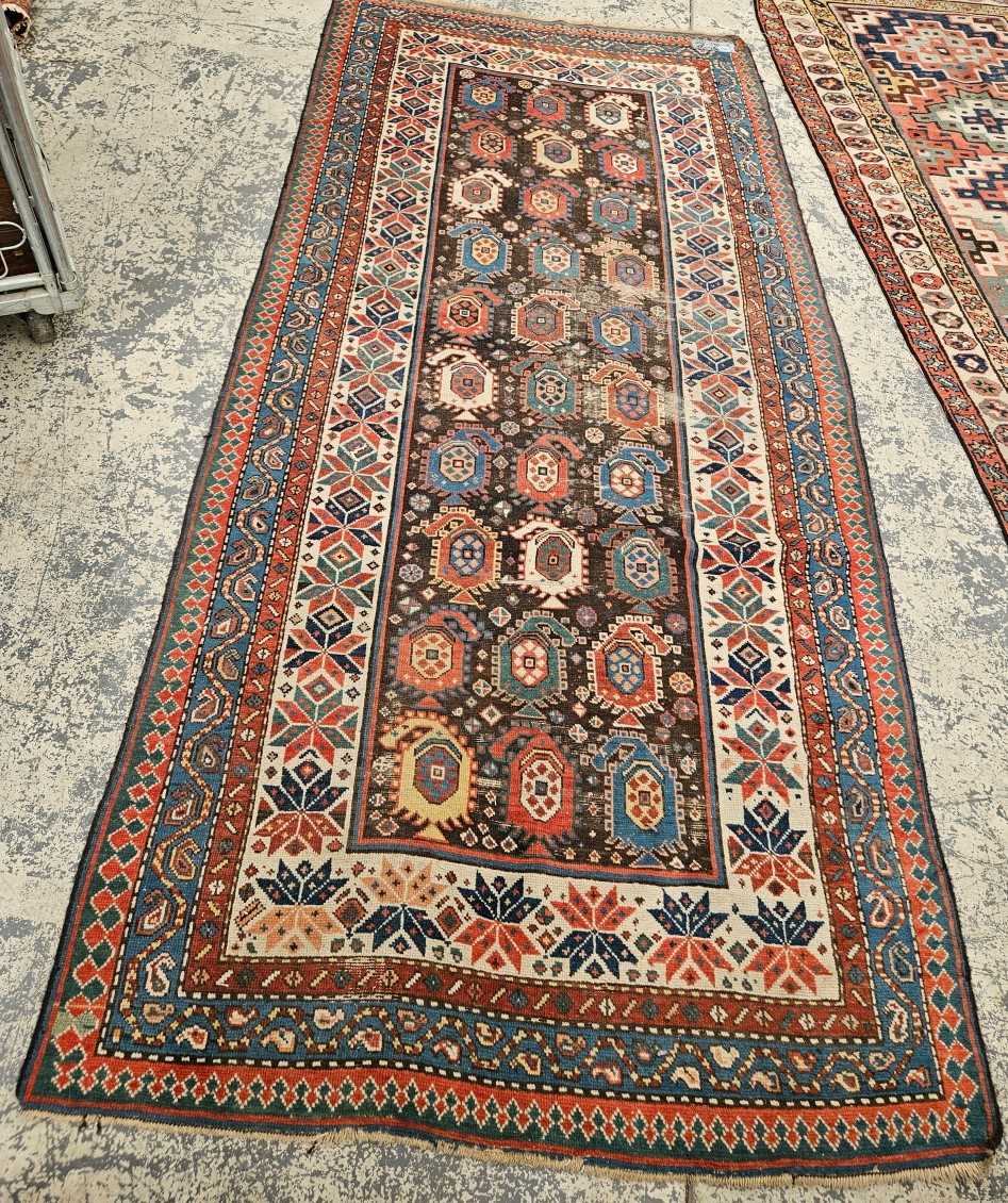 AN ANTIQUE CAUCASIAN TRIBAL RUG.