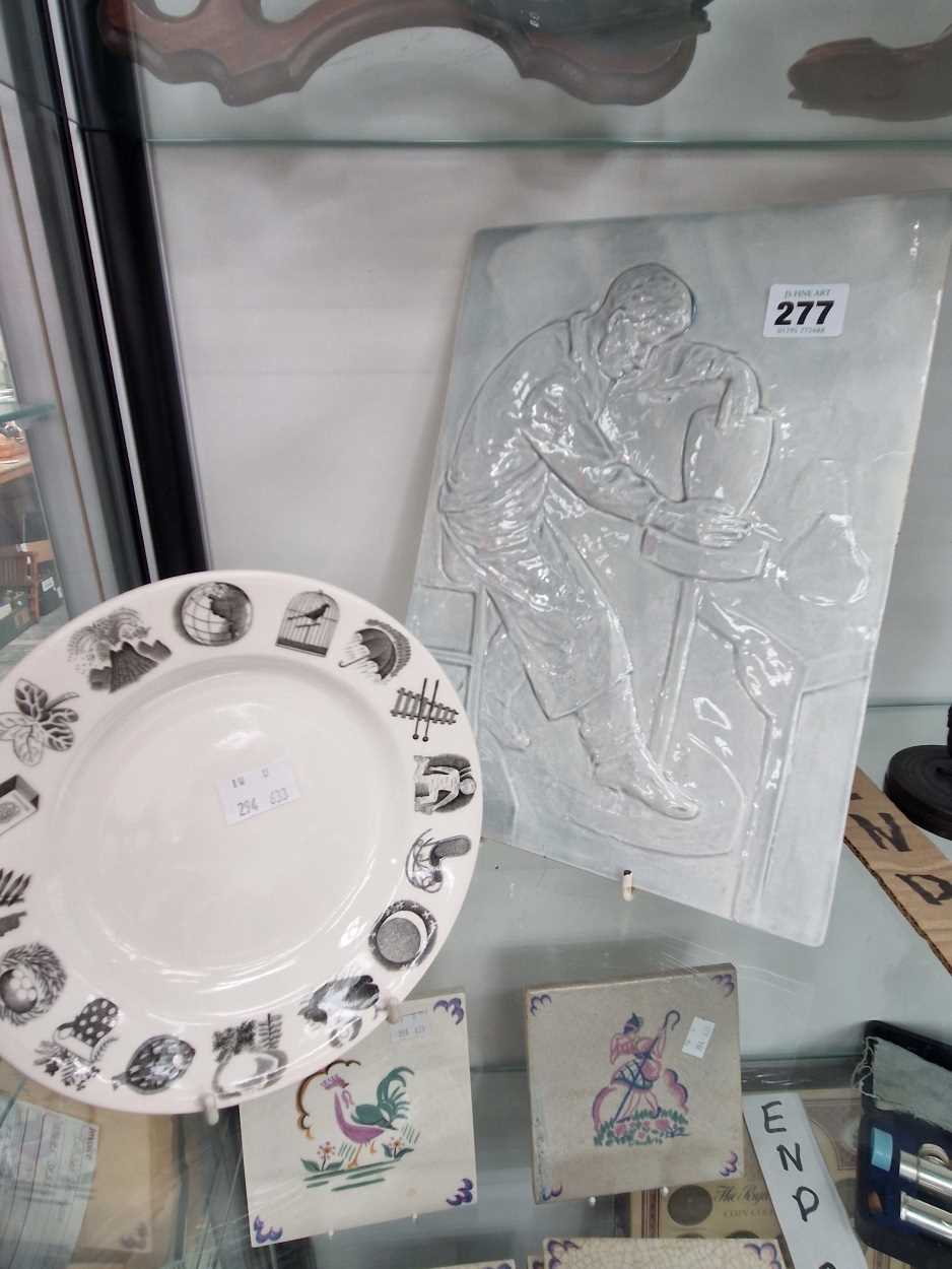 A tile relief cast with a potter at his wheel together with a Wedgwood Ravilious tea plate Thank you