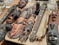 Various tribal wooden masks, a Chinese lacquered model dragon boat together with a pair of angel