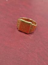 An unhallmarked signet ring with engraved shield. Assessed as 21ct gold. Weight 8.26grms.