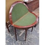 A mahogany demi lune fold over card table.