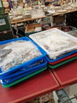 Eight trays of various sorted and bagged items of costume jewellery.