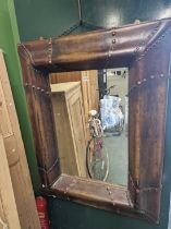 An unusual leather framed mirror.