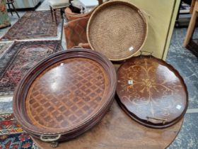 An Edwardian inlaid wine tray, a large inlaid walnut and gilt brass mounted deep tray and a rattan