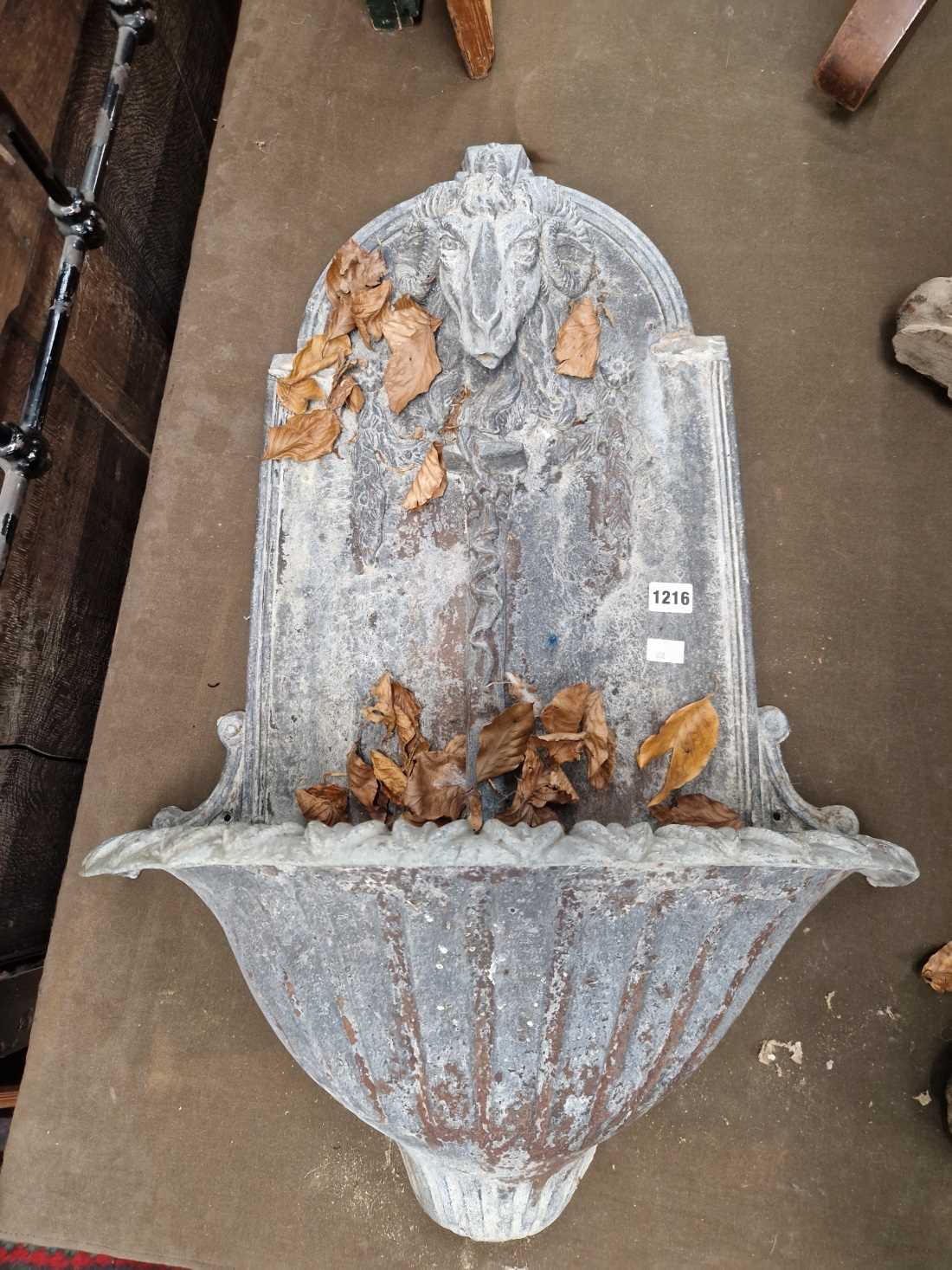 A cast lead wall fountain. H 90 W 53 D 26 cm.