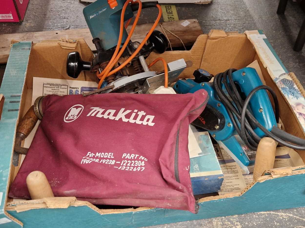 A Makita sanding tool, a Black & Decker micro adjustment saw, a two handled pit saw,