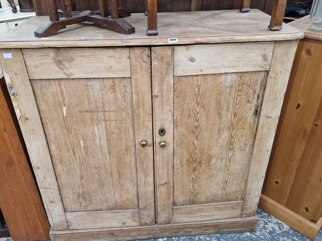 A Victorian pine two door cabinet and a kitchen chair