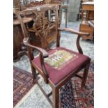 A pair of Georgian style armchairs with needle point seat pads.