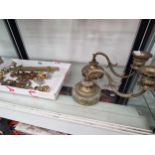 A pair of brass candlesticks on arms scrolling from and adjustable on weighted bases together with