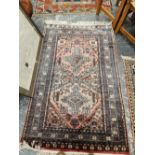 A PERSIAN MAT, TOGETHER WITH AN ORIENTAL RUG OF CAUCASIAN DESIGN 162 x 102 cm