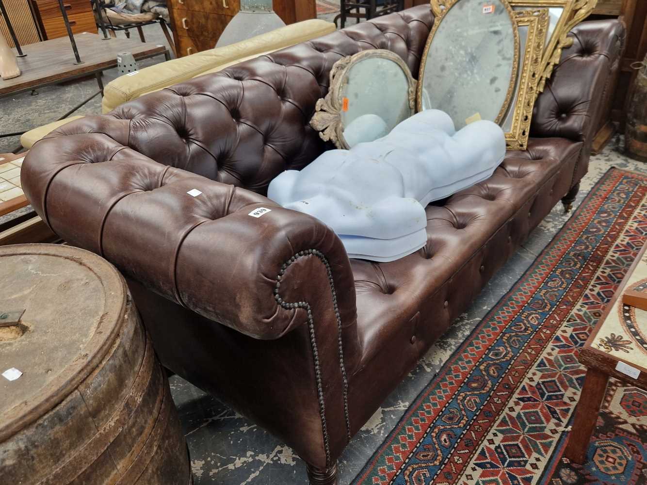 Leather upholstered Chesterfield settee.