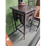 An Arts and Crafts black painted occasional table.
