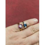 A 9ct hallmarked gold ruby and diamond cluster ring, and a three stone unhallmarked ring assessed as