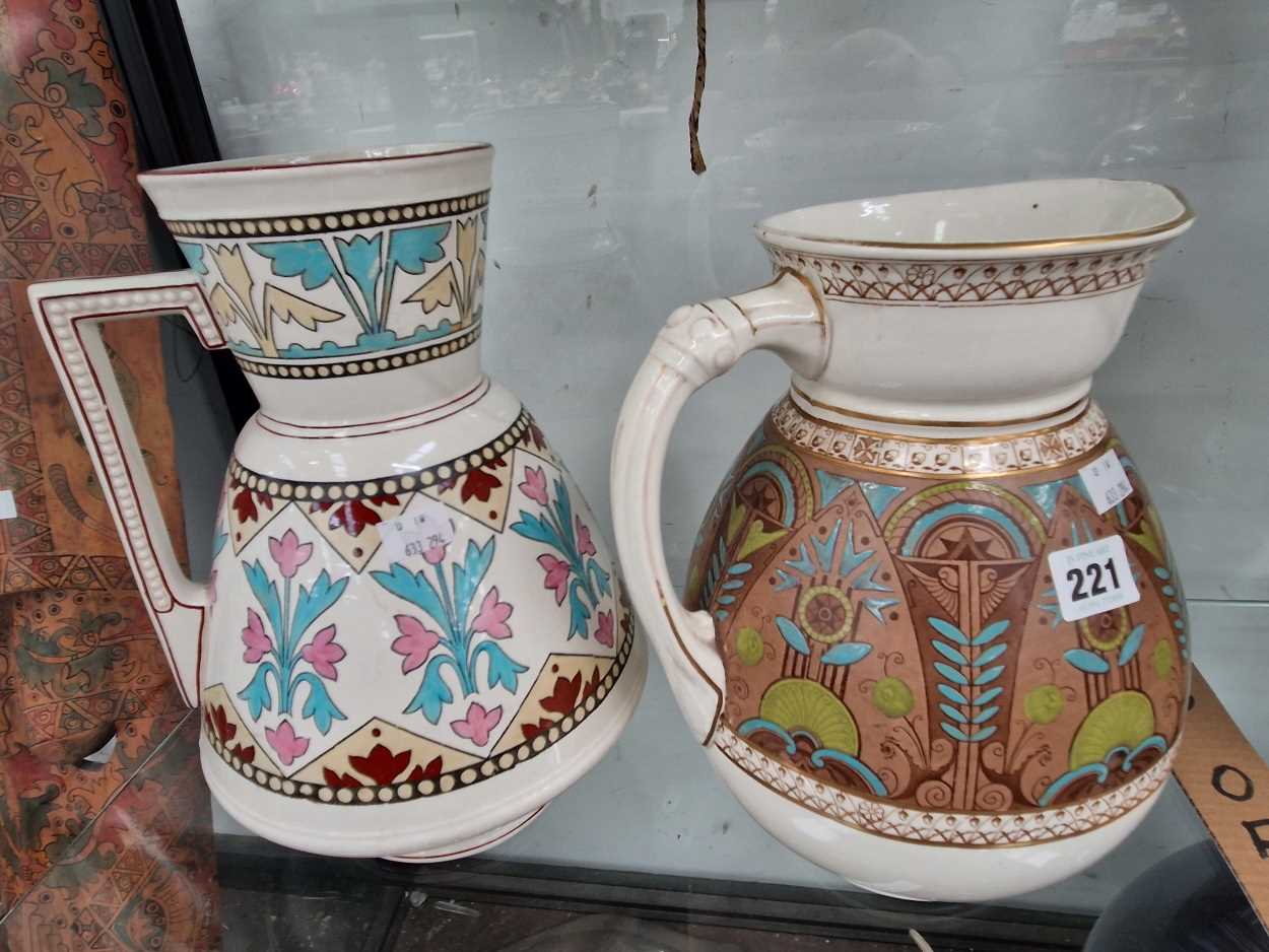 Two pottery wash jugs decorated in Pugin taste The jug with pink decoration has a hairline