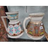 Two pottery wash jugs decorated in Pugin taste The jug with pink decoration has a hairline