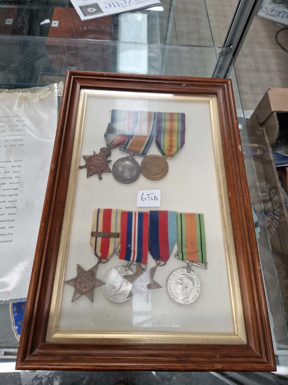 A frame of three WWI medals together with four WWII medals named to George James Hall (WWI) and