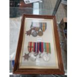 A frame of three WWI medals together with four WWII medals named to George James Hall (WWI) and