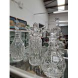 Four various decanters together with a vase with a trailed open work top