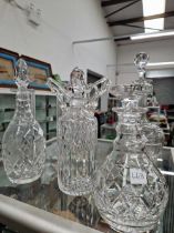 Four various decanters together with a vase with a trailed open work top