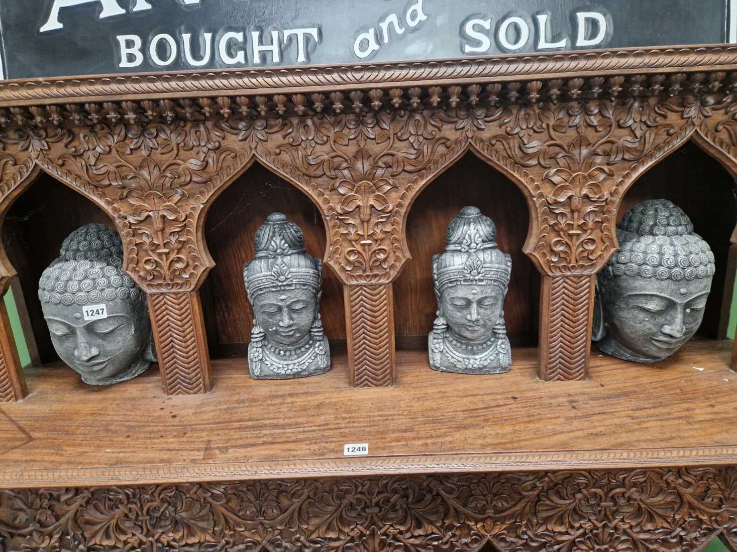 A group of 4 Eastern stoneware Deity heads.