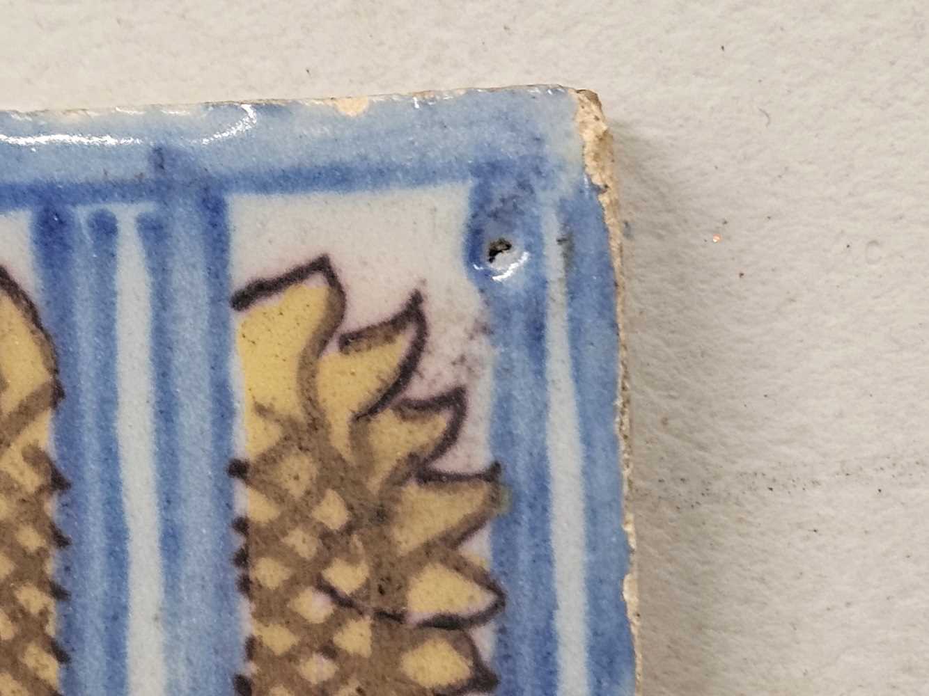 A tin glazed tile painted in blue, yellow and aubergine with a sunflower 15 x 15 cm - Image 5 of 15
