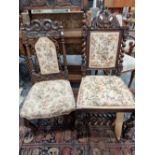 Two carved oak side chairs.