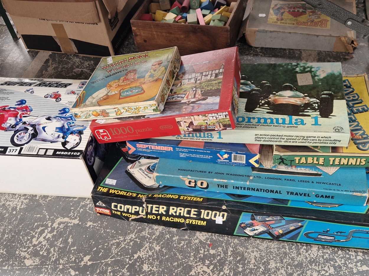 A boxed electric racing game, Computer Race 1000 a boxed motorbike racing game, board games, etc