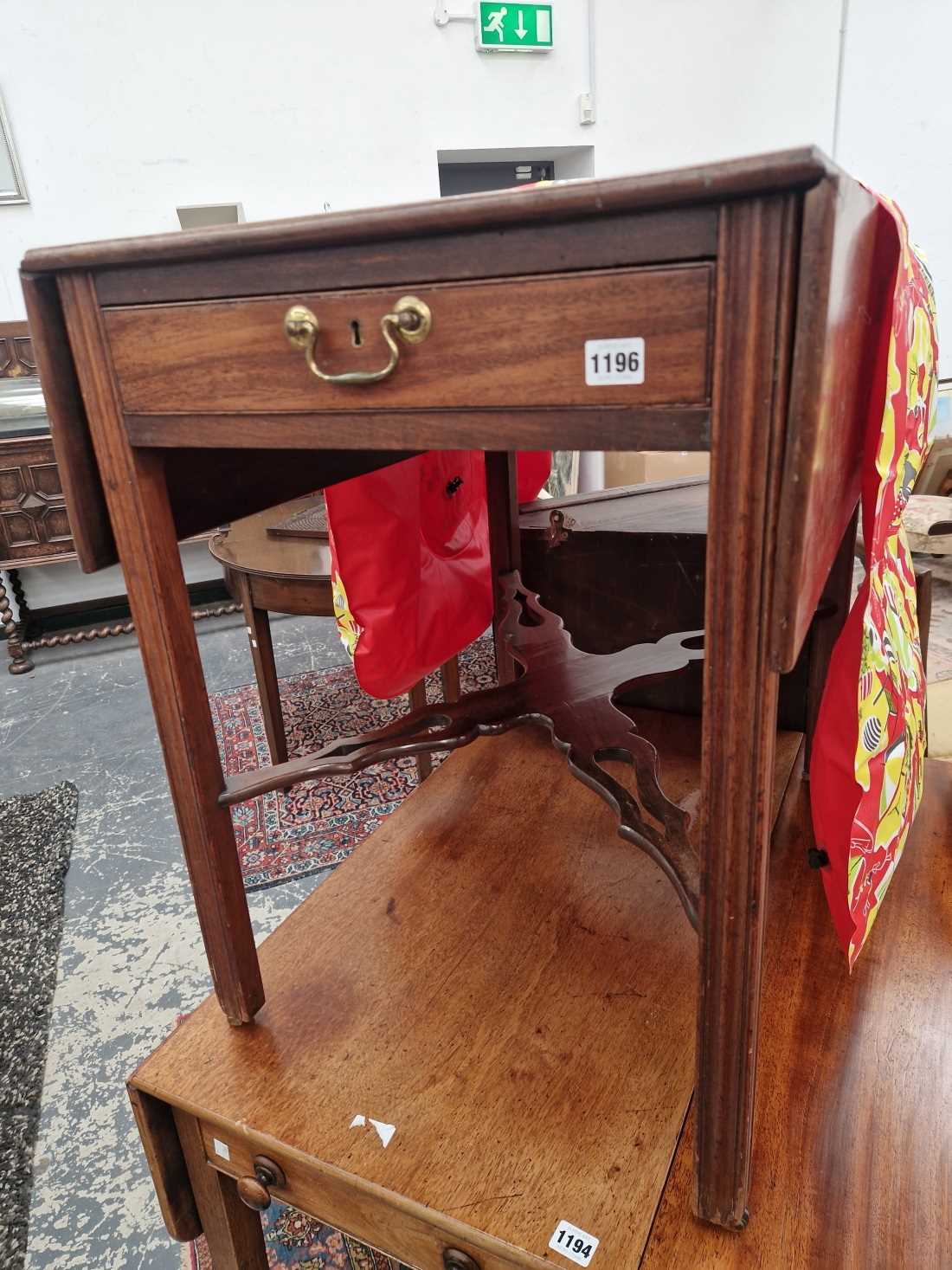 A Georgian mahogany tea table with drop leaf top and shaped undertier.