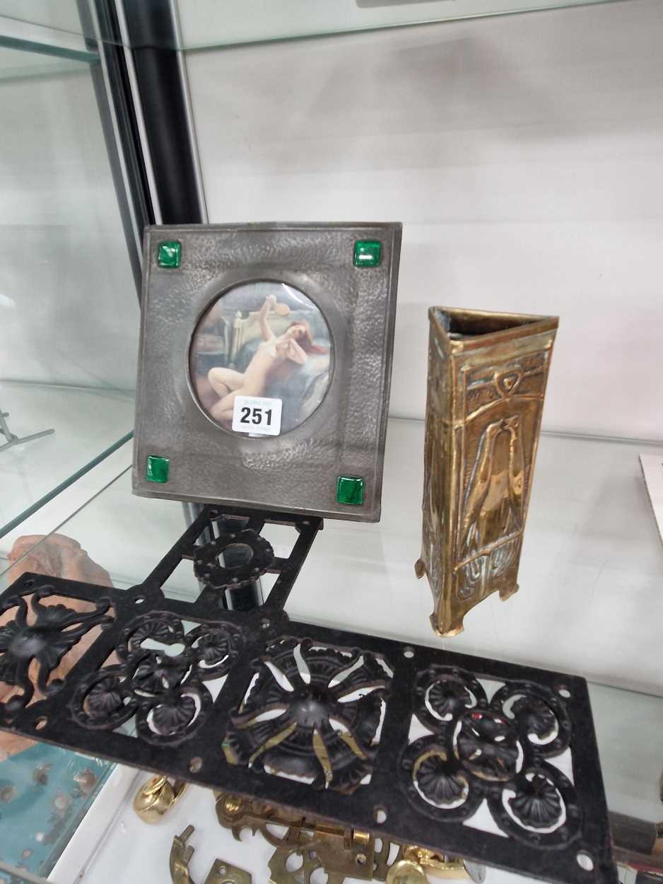 An Osiris hammered pewter photograph frame, a brass spill vase of triangular section and an
