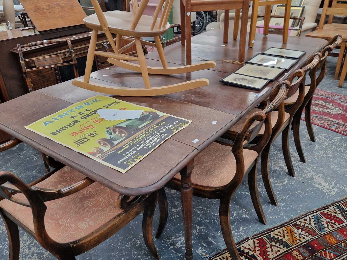 A large Victorian mahogany extending dining table. This has bracket arms to support the drop leaf