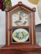 A Seth Thomas clock with its glass door printed with flowers