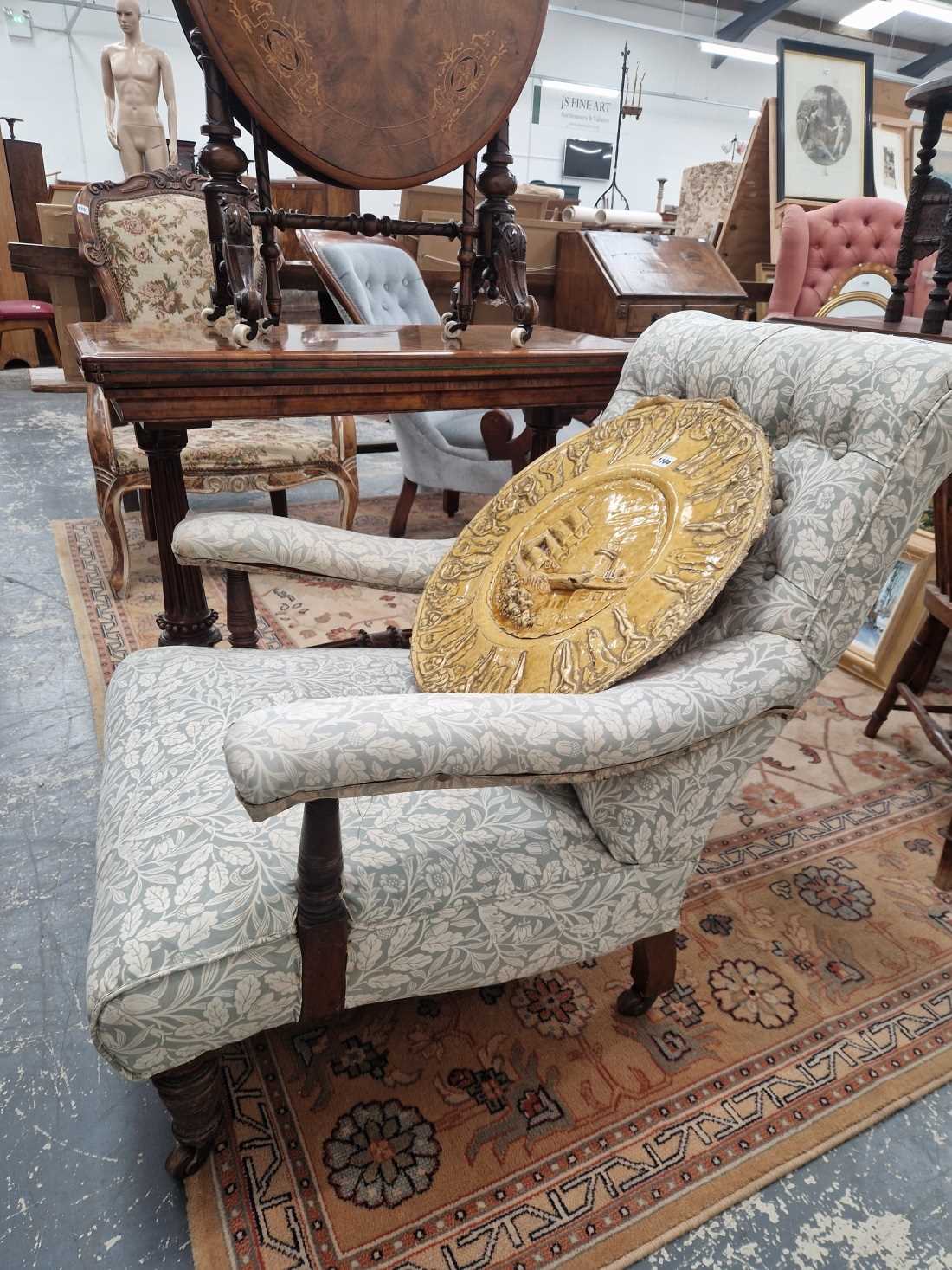 A Victorian deep seat arm chair. Sound and usable. Upholstery is scruffy with some losses and tears.