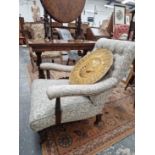 A Victorian deep seat arm chair. Sound and usable. Upholstery is scruffy with some losses and tears.