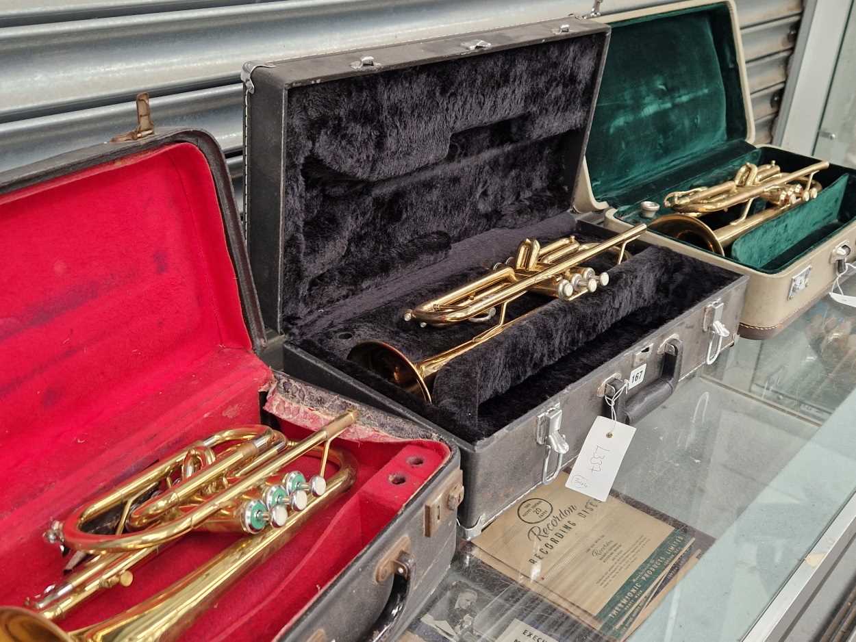 Three cased brass trumpets: two by Arbetter and one by Skylark