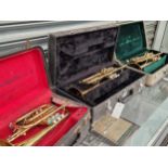 Three cased brass trumpets: two by Arbetter and one by Skylark